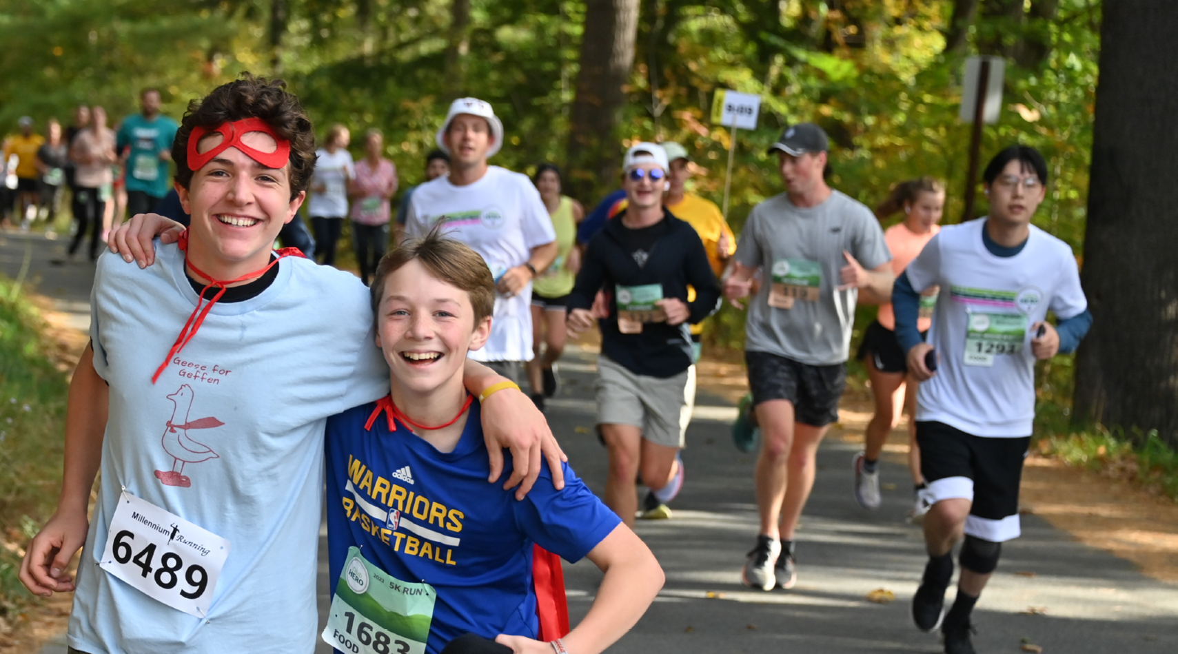 Two boys running and smiling in the CHaD event