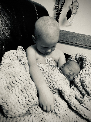 Wyatt with his newborn brother while in treatment